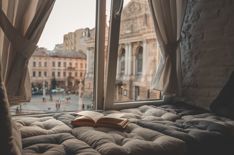 Cozy reading nook with window seat and soft curtains warm atmosphere